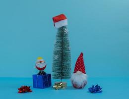 Santa Claus and Christmas gnome around the New Year tree with gifts. Merry Christmas. photo