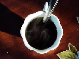 cup of steaming black coffee in an Italian restaurant in western Liguria photo