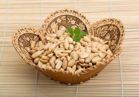 Peanut in a basket on wooden background photo