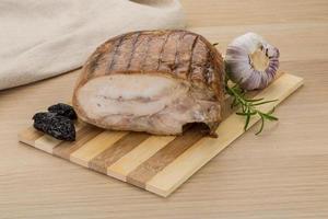 Turkey roll on wooden board and wooden background photo