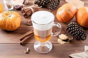 Pumpkin spice latte in a glass mug with cinnamon and ginger photo