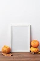 Art photo frame mockup with scarfs and autumn leaves, white background