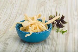 Dried squids in a bowl on wooden background photo