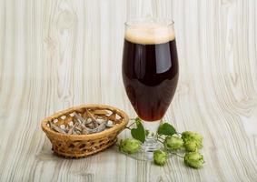 Beer with hop on wooden background photo