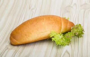 Loaf bread on wooden background photo