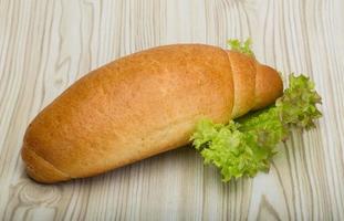 Loaf bread on wooden background photo