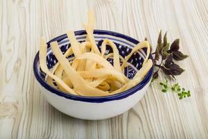 Dried squids in a bowl on wooden background photo