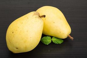 Yellow pears on wooden background photo