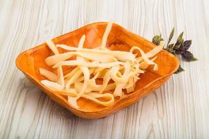 Dry calamari in a bowl on wooden background photo