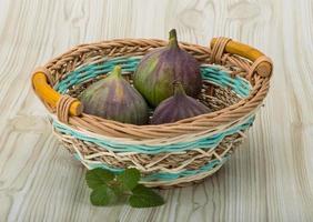 Figs in a basket on wooden background photo