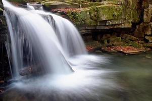 Autumn waterfall in forest photo