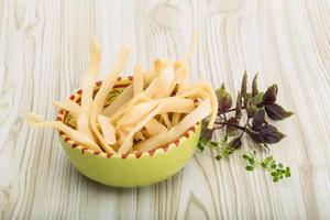 Dried squids in a bowl on wooden background photo