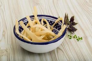 Dried squids in a bowl on wooden background photo