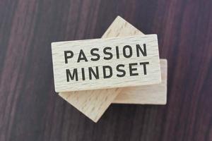 Passion mindset word on wooden block with wooden background. photo