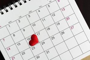 Red heart shape on the date of the 16th day in the calendar. photo