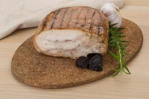 Turkey roll on wooden board and wooden background photo