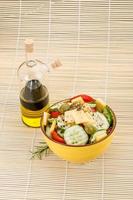 Greek salad in a bowl on wooden background photo