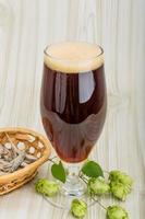 Beer with hop on wooden background photo