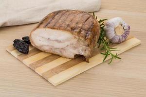 Turkey roll on wooden board and wooden background photo