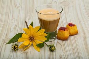 Coffee with milk on wooden background photo