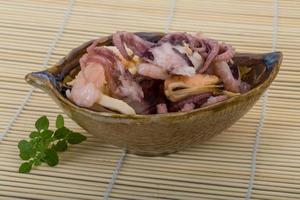 Seafood cocktail in a bowl on wooden background photo