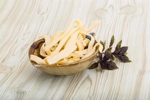 Dry calamari in a bowl on wooden background photo