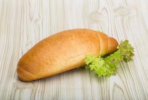 Loaf bread on wooden background photo