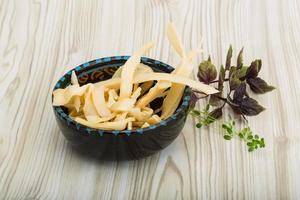 Dried squids in a bowl on wooden background photo