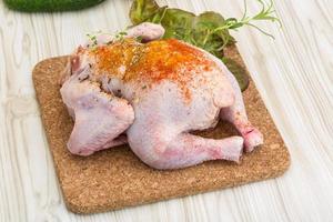 Raw chicken on wooden board and wooden background photo