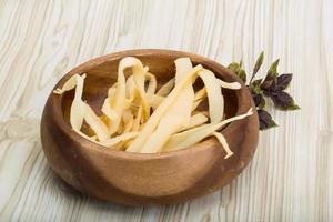 Dry calamari in a bowl on wooden background photo