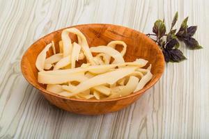 Dry calamari in a bowl on wooden background photo