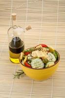 Greek salad in a bowl on wooden background photo