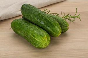 Cucumber on wooden background photo