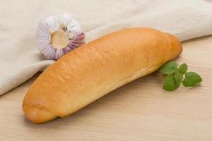 Fresh baked bread on wooden background photo