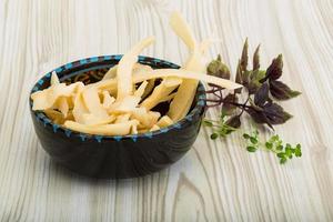 Dried squids in a bowl on wooden background photo