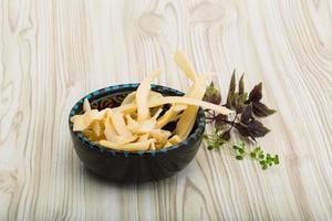 Dried squids in a bowl on wooden background photo