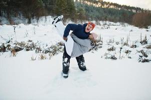Couple hugs in winter nature. Outdoors in snow. photo