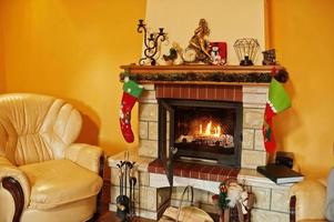 Home fireplace in warm living room on winter day. photo