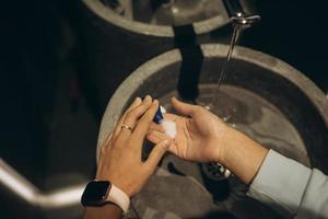 Man washing hands to protect against the coronavirus photo