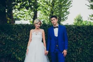 Beautiful wedding couple posing in the park photo
