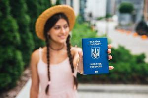 The woman shows her passport to the camera photo