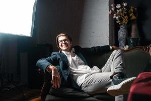 close-up portrait of an attractive young man relaxing on the couch photo