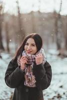 Young beautiful model posing in winter forest. stylish fashion portrait photo