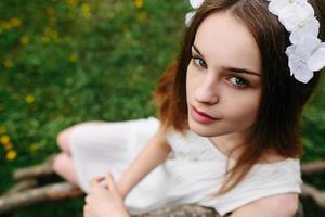 Lovely girl near a wooden house photo