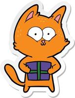 pegatina de un gato de dibujos animados sosteniendo un regalo de navidad vector
