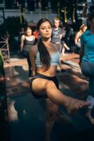 A woman does yoga together with her group in the open air photo