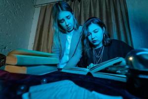 Two women are reading a mysterious book photo