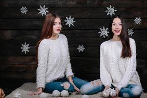 Two beautiful girls sitting on the floor photo