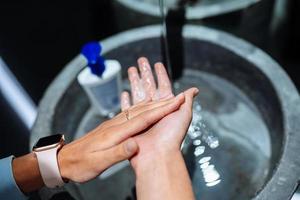 Man washing hands to protect against the coronavirus photo