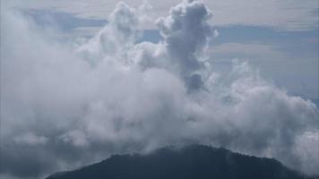Aerial view of sea of fog on tropical mountains in the early morning. Layers of mountains in Thailand. Landscape of nature background in motion. video